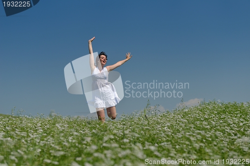 Image of Young happy woman in green field