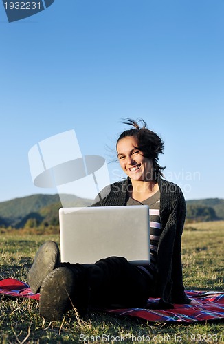 Image of young teen girl work on laptop outdoor