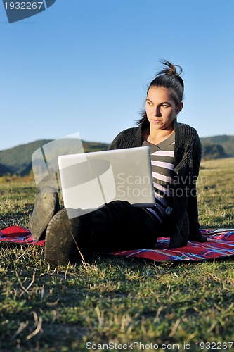 Image of young teen girl work on laptop outdoor