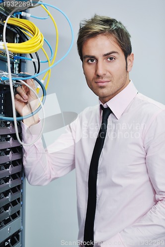 Image of young it engineer in datacenter server room