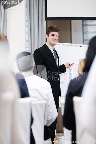 Image of Young  business man giving a presentation on conference
