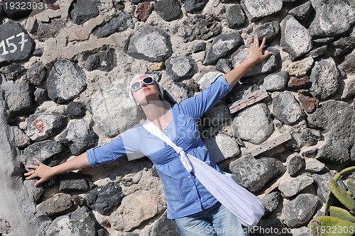 Image of Greek woman on the streets of Oia, Santorini, Greece