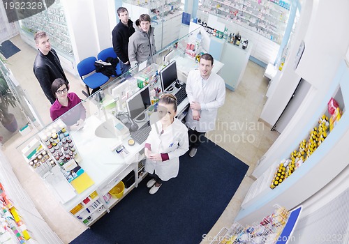 Image of pharmacist suggesting medical drug to buyer in pharmacy drugstor