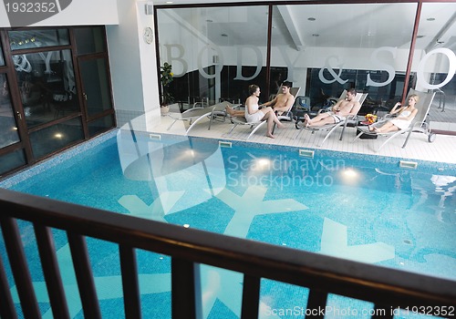 Image of young people group at spa swimming pool