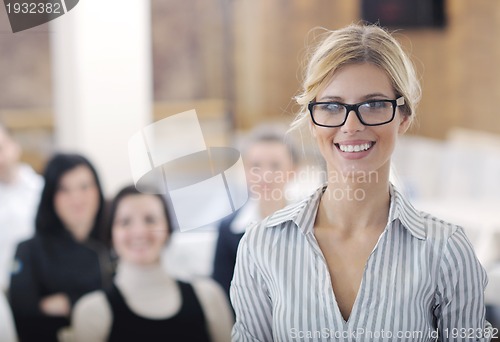Image of business woman standing with her staff at conference