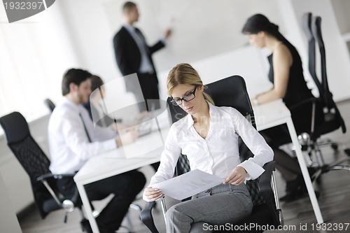 Image of business woman with her staff in background