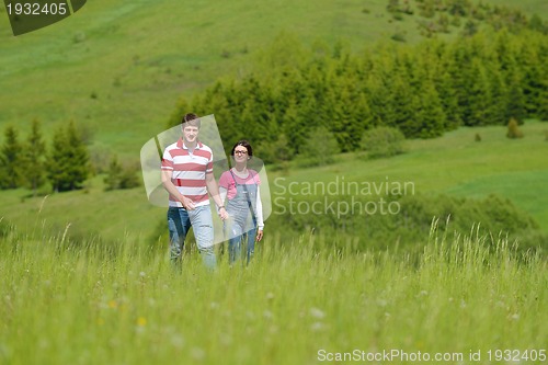 Image of Portrait of romantic young couple smiling together outdoor