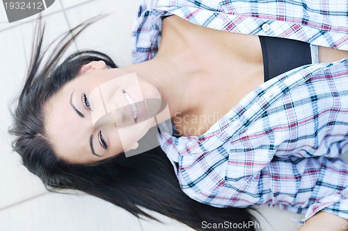Image of beautiful young lady posing in garden
