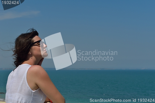 Image of young woman with spreading arms to sky
