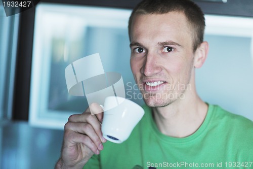 Image of handsome young man drink fresh morning coffee