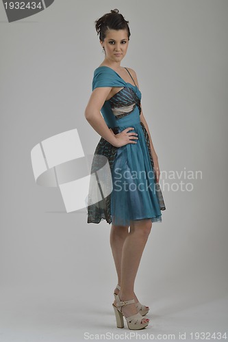 Image of elegant woman in fashionable dress posing in the studio