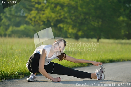 Image of Young beautiful  woman jogging at morning in park