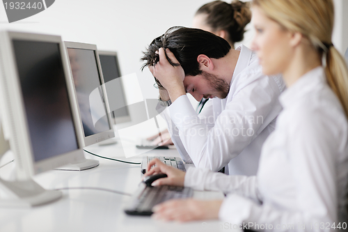 Image of tired and depresed young business man at office