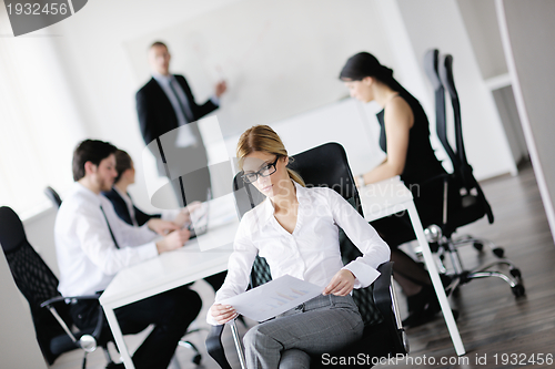Image of business woman with her staff in background
