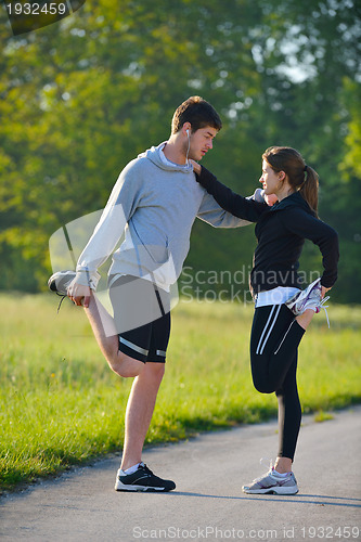 Image of Couple doing stretching exercise  after jogging