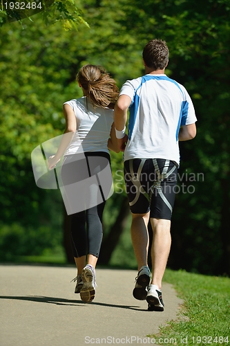 Image of Young couple jogging at morning