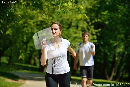 Image of Young couple jogging at morning