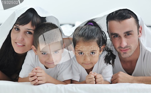 Image of happy young Family in their bedroom