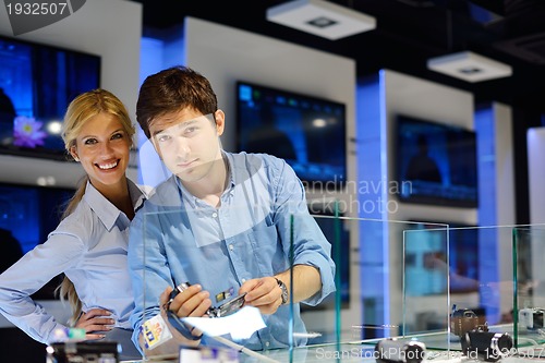 Image of Young couple in consumer electronics store