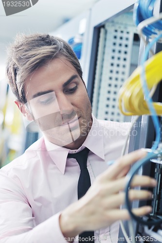 Image of young it engeneer in datacenter server room