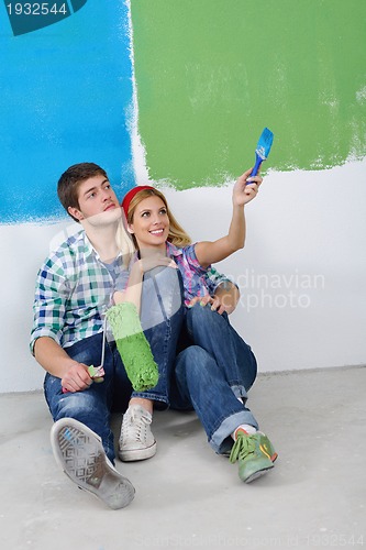Image of happy young cople relaxing after painting in new home