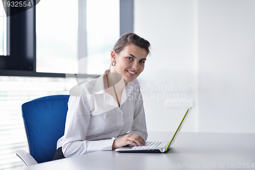Image of Young pretty business woman with notebook in the office