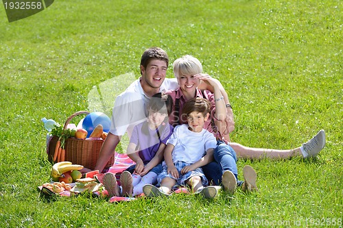 Image of Happy family playing together in a picnic outdoors