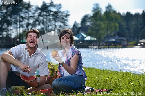 Image of happy young couple having a picnic outdoor