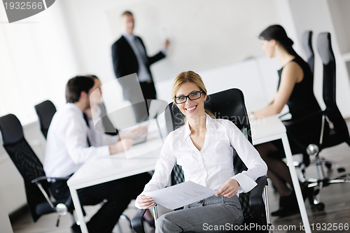 Image of business woman with her staff in background