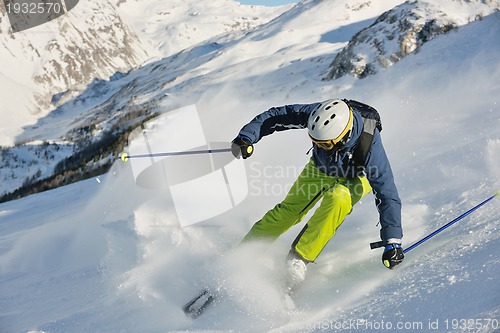 Image of skiing on fresh snow at winter season at beautiful sunny day