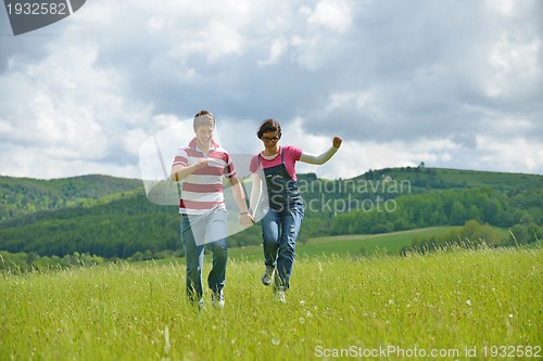 Image of Portrait of romantic young couple smiling together outdoor