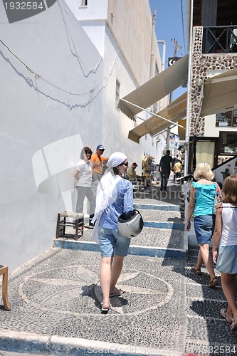 Image of Greek woman on the streets of Oia, Santorini, Greece