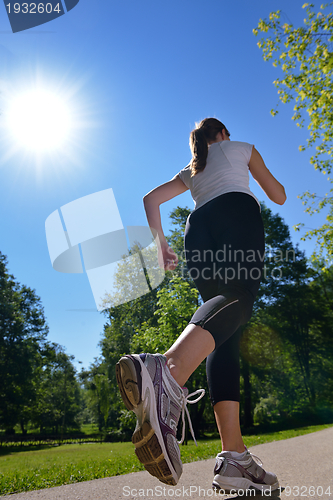 Image of Young beautiful  woman jogging at morning in park