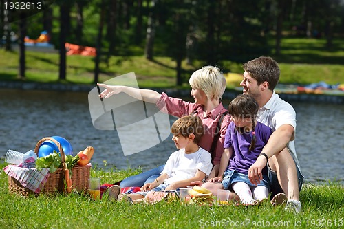 Image of Happy family playing together in a picnic outdoors