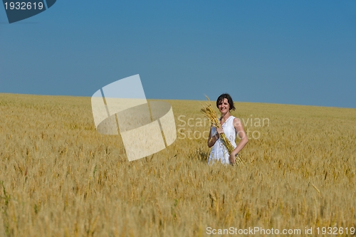 Image of young woman in wheat field at summer
