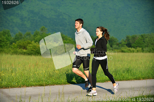 Image of Young couple jogging