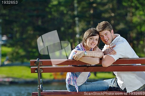 Image of Portrait of romantic young couple smiling together outdoor