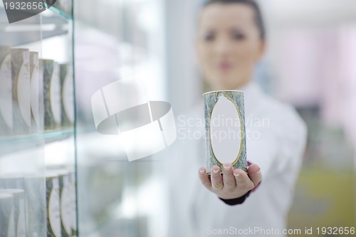 Image of pharmacist chemist woman standing in pharmacy drugstore