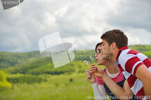 Image of Portrait of romantic young couple smiling together outdoor