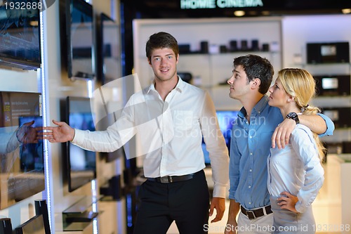 Image of Young couple in consumer electronics store