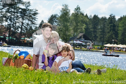Image of Happy family playing together in a picnic outdoors