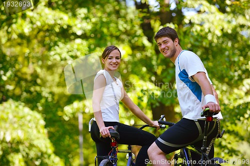 Image of Happy couple ridine bicycle outdoors