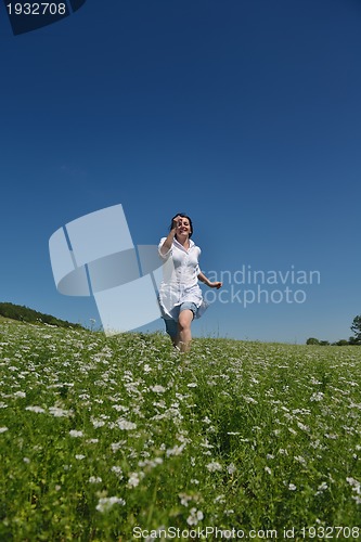 Image of Young happy woman in green field
