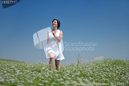 Image of Young happy woman in green field