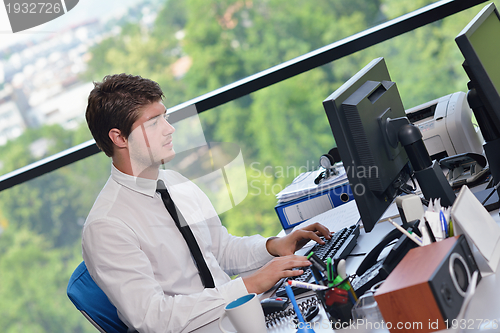 Image of happy young business man at office