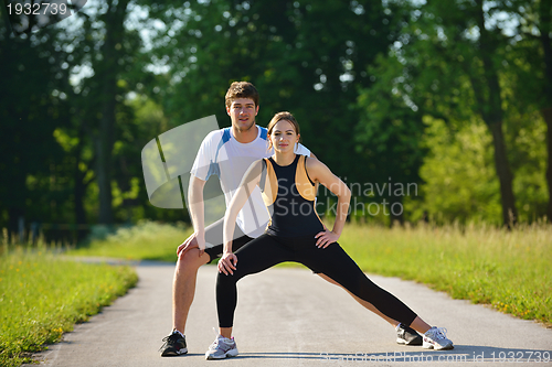 Image of Couple doing stretching exercise  after jogging