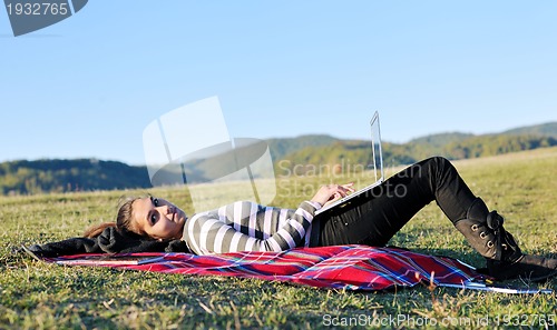 Image of young teen girl work on laptop outdoor