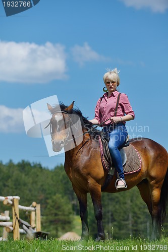 Image of happy woman  on  horse