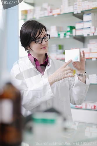 Image of pharmacist chemist woman standing in pharmacy drugstore