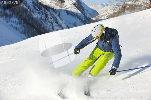 Image of skiing on fresh snow at winter season at beautiful sunny day